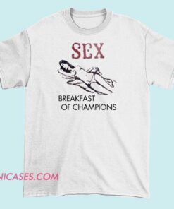 A T-shirt featuring the phrase "Sex Breakfast of Champions" with bold typography and playful or provocative graphics, designed to make a humorous or edgy statement.