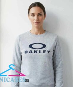 Vintage Oakley light blue graphic sweatshirt, black cotton graphic shirt, retro sportswear inspired design, unisex short sleeve style, sizes S to 2XL, Inicases apparel