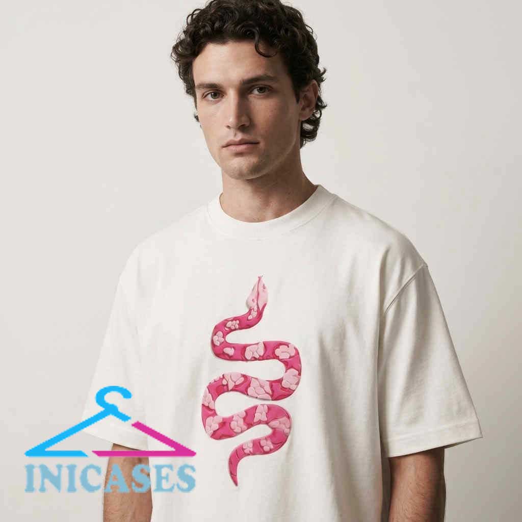 Camo Snake Art And Rose Pink Inspired Shirt Pink floral snake graphic tee shirt with a detailed snake pattern, floral artwork, cotton fabric, short sleeves, and versatile streetwear styling.