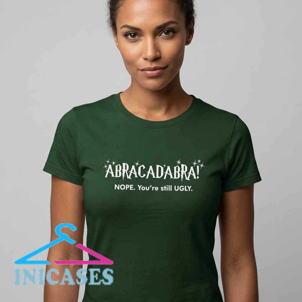 Funny You're Still Ugly Abracadabra T-Shirt Funny You're Still Ugly Abracadabra T-Shirt, humorous magic quote graphic tee, cotton short sleeve shirt for casual streetwear fans, available in black and white.